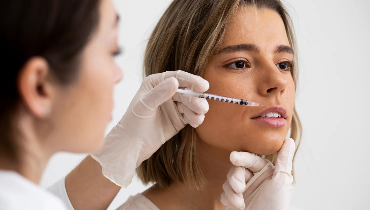 doctor injecting woman's lips