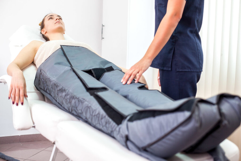 Young beautiful woman in the salon for beauty. The treatment of cellulite and lymphatic drainage